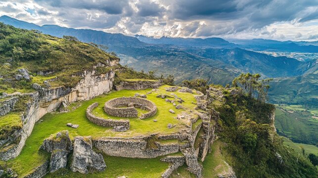 Bird's-eye view of the ancient ruins of Kuelap, with its circular stone walls and mountainous backdrop