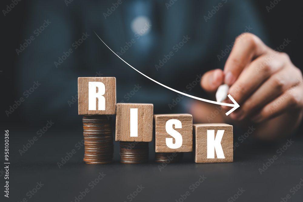 Poster Risk wording on decreasing coins stacking with down arrow for financial banking risk analysis and management ,Low risk low return concept.