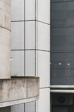 This photograph captures the facade of a modern building, featuring a combination of concrete and grid-like patterns, showcasing architectural design and urban aesthetics.