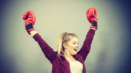 Woman winner wearing boxing gloves