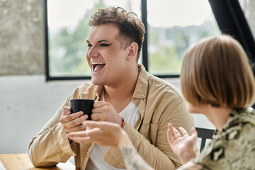 Friends share laughter and coffee in a cozy home atmosphere.