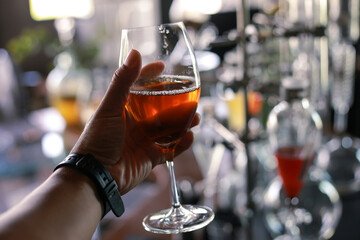 Selective Focus Wine in a clear glass in hand In a beverage shop Fresh wine that is experimentally produced by ourselves