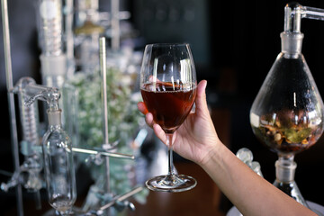 Selective Focus Wine in a clear glass in hand In a beverage shop Fresh wine that is experimentally produced by ourselves