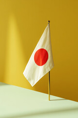 Japanese flag on a flagpole against color background
