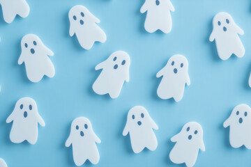 Cute white ghosts pattern on bright color background