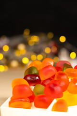 Christmas Gummy Colorful Candy on Garland Background.