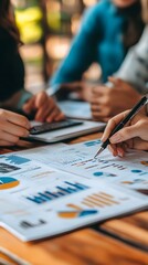Group of business partners discussing a business plan with graphs and financial data
