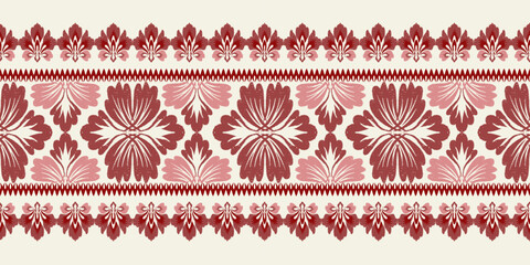 A linear ikat damask pattern in shades of red and pink, with detailed floral elements on a cream background. This border-style design adds a touch of elegance to fabric and wallpaper applications.