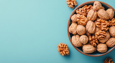 Fresh walnuts in a bowl on a blue background, showcasing their natural texture and color