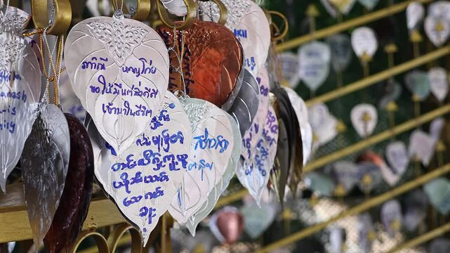 Golden leafs with names and wishes at Golden Mountain Temple, Wat Saket, Bangkok, Thailand.
