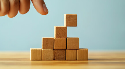Obraz premium Building Blocks of Business Success - Close Up of Hands Arranging Wood Blocks for Growth, Copy Space in Background
