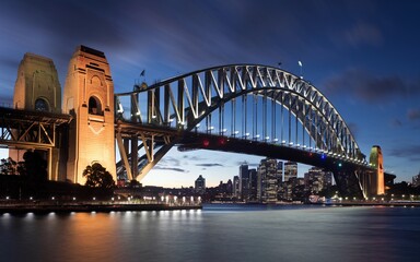 Naklejka premium Sydney Harbour Bridge with City Skyline Sunrise Background