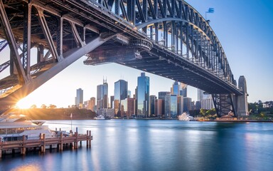 Fototapeta premium Sydney Harbour Bridge with City Skyline Sunrise Background