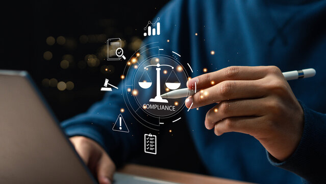 Compliance in business concept. Laws concept. Enforce laws, regulations and standards, comply with business policies, Businessman use laptop with compliance icon on virtual screen.