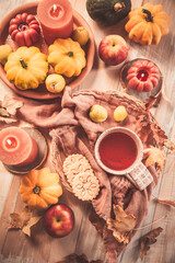 Cup of hot tea with pumpkins and autumn fruits. Happy Thanksgiving and Hello fall concept.