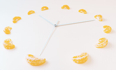 Creative clock styled citrus indoor shot on white background