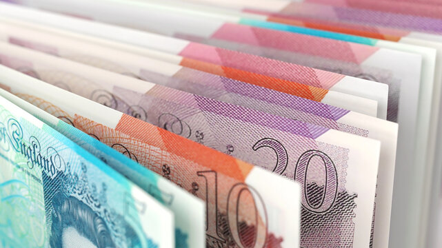 Close-up view of British pound banknotes in different denominations, emphasizing UK currency and finance