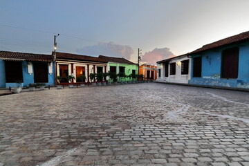 The AD 1732 last laid Plaza San Juan de Dios Square colonial buildings with red tiled-roofed houses, iron gilles, cobblestones. Camaguey-Cuba-365