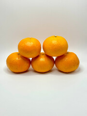 Pyramid of Fresh Oranges on a Clean White Background.