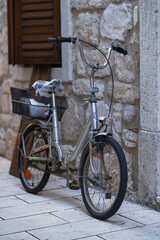 old bicycle leaning against a wall