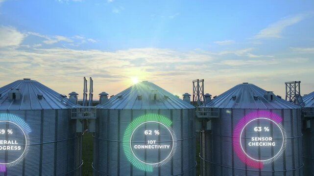 Digital Farm Data On Agricultural Grain Silos. Smart Farming Technology. Drone sideways shot