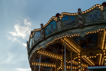 carousel at sunset, colorful amusement park. city festival
