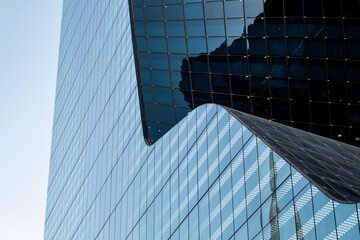 building in the city, Huge curved glass facade office building, contemporary architecture in Dubai,...