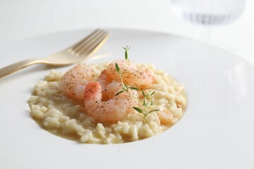Delicious risotto with shrimps and cheese on plate, closeup