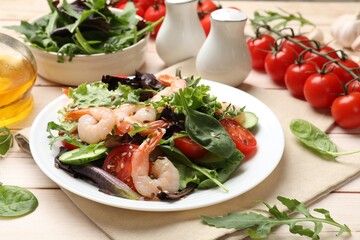 Delicious shrimp salad and ingredients on wooden table, closeup