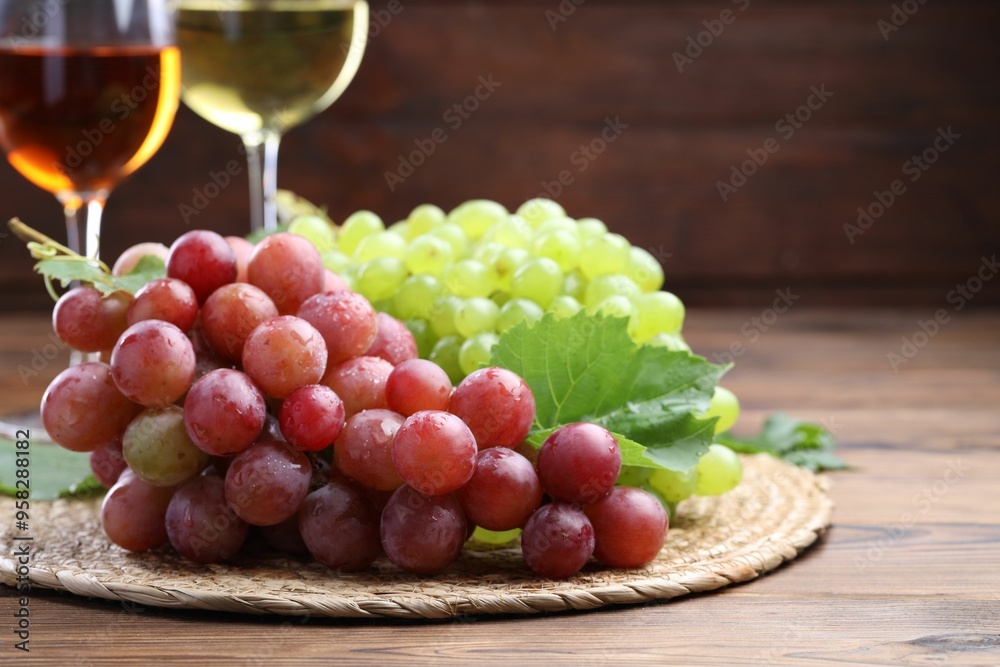 Canvas Prints Fresh ripe grapes and glasses of wine on wooden table, closeup