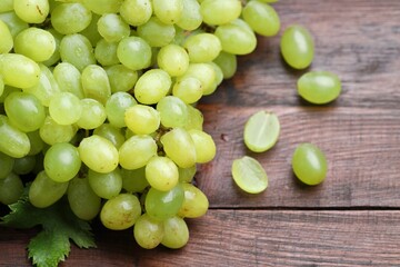 Fresh ripe grapes on wooden table, closeup
