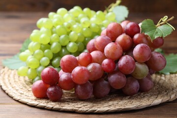 Fresh ripe grapes on wooden table, closeup