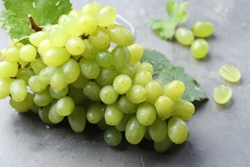 Fresh ripe grapes on grey table, closeup