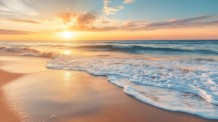 Gentle waves washing over a sandy beach at sunrise