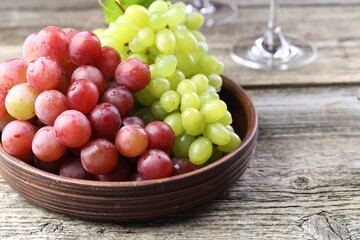 Delicious fresh ripe grapes on wooden table