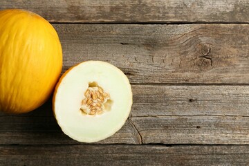Fresh ripe melons on wooden table, top view. Space for text