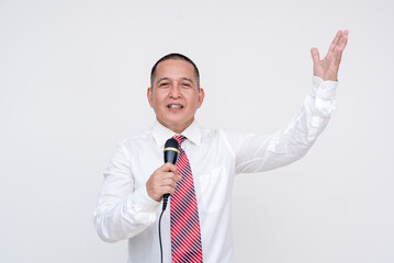 A local middle aged asian politician giving a speech with microphone in hand and making animated gestures. Campaigning of reelection. Set against a white background.