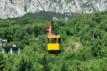 Cable car with yellow Funicular cabin, cable transportation system, mountains trip, tourism industry