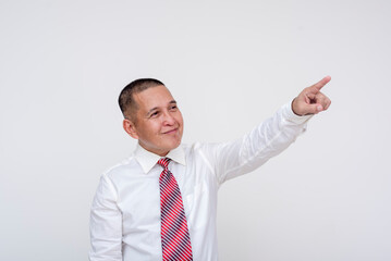 An ambitious middle aged office male professional visualizing company growth with an upward gesture of his finger. Set against a white background.