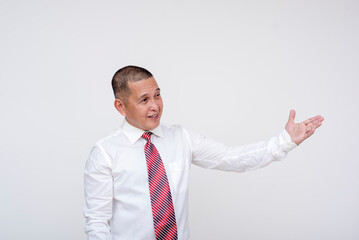 Friendly middle aged office male professional introducing someone or something to the right, with a hand gesture. Isolated on a white background.