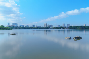 Fototapeta premium City park lake scenery with blue sky and white clouds