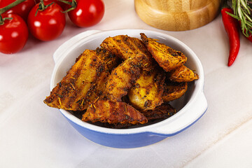 Golden baked potato Idaho with spices