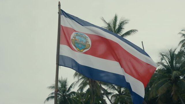 Costa Rican flag waving in the wind along the beach