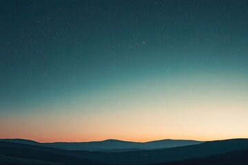 Fototapeta premium A tranquil sunset over rolling hills, creating a serene atmosphere with blended colors in the sky.