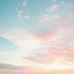 Obraz premium A serene sunset sky painted in soft pastel hues of pink and blue, perfect for evoking calm and tranquility.
