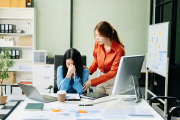 Furious two Asian businesspeople arguing strongly after making a mistake at work