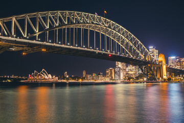 Cityscape image of Sydney, Australia with Harbour Bridge and Opera house during night time.