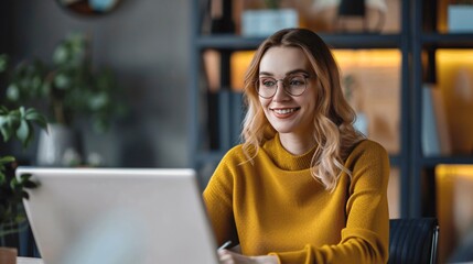 Smiling Woman Working on Laptop in Modern Office
