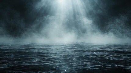 A beam of light shines through a dense fog over a dark, rippling body of water.