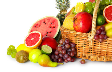 Many different fresh fruits in wicker basket isolated on white